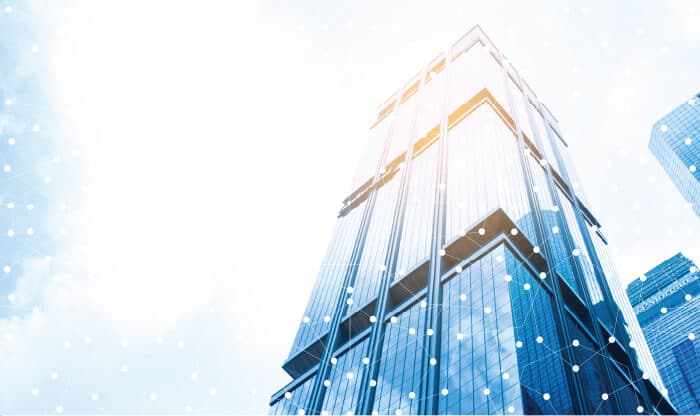 Image for the "Benefit 1" on the GOL-IT homepage containing skyscraper photographed from the bottom. The image over it has multiple circles and thin white lines graphics.